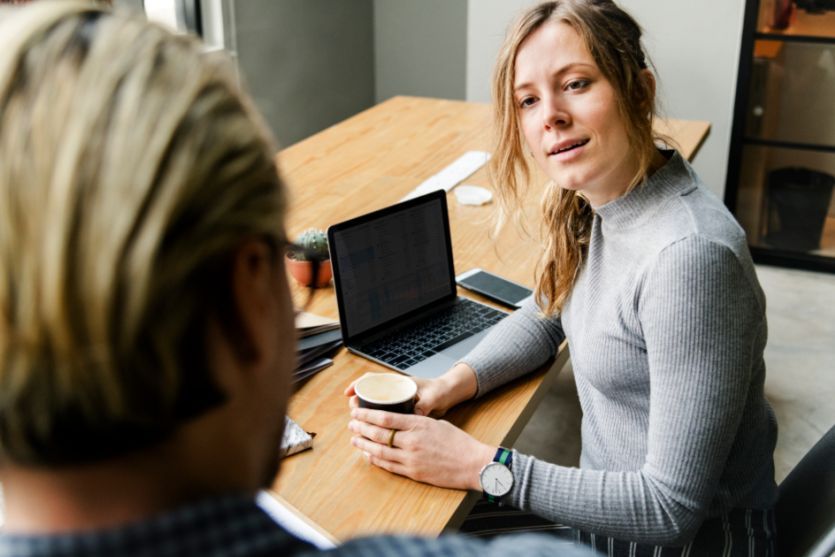 woman with laptop talking with business man