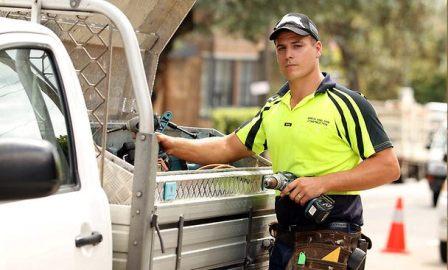 tradesperson tradesman getting tools out of ute